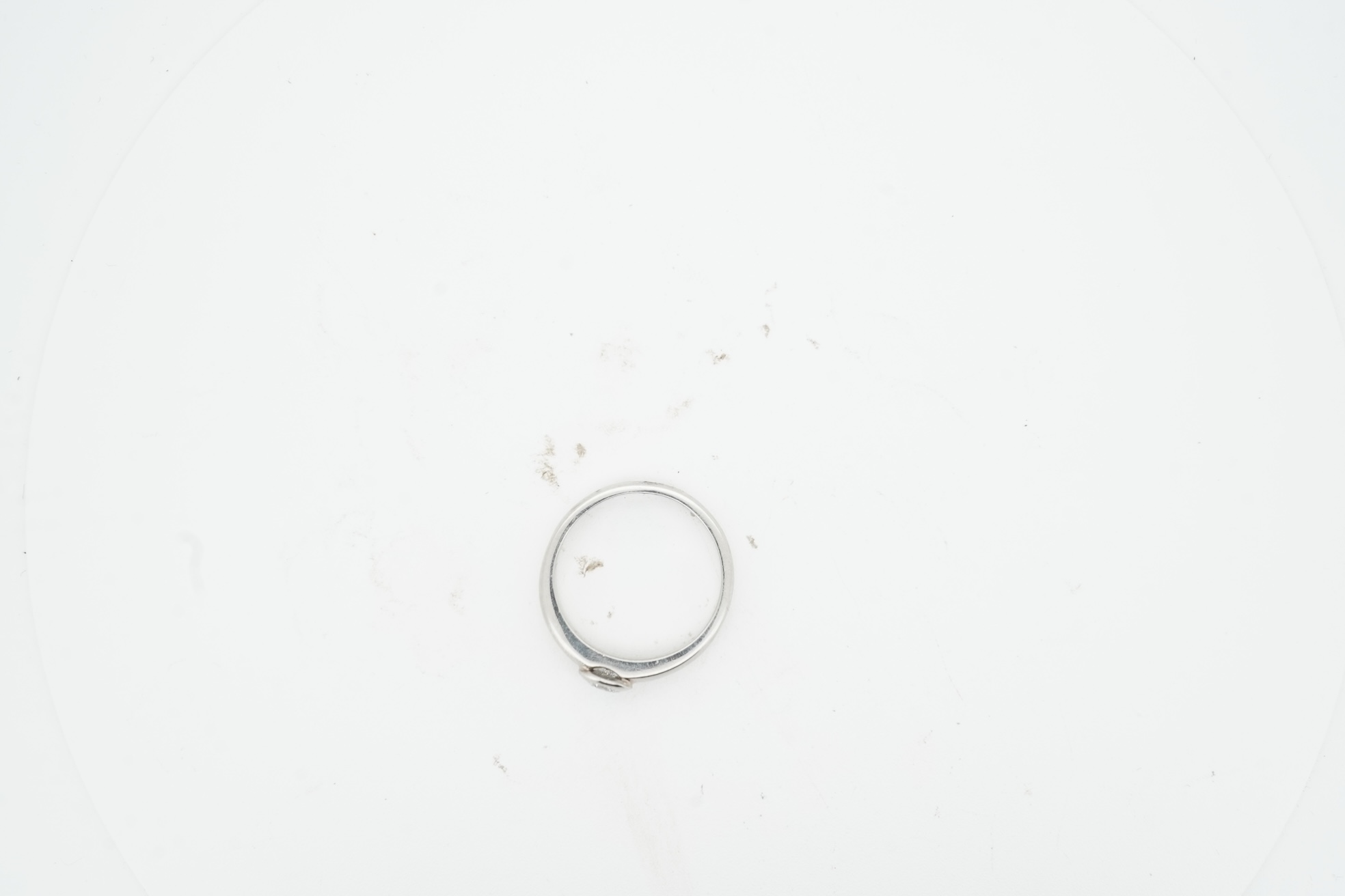 A diamond ring, collet-set with a brilliant-cut diamond weighing approximately 0.52 carats, mounted in platinum, size K1/2, British hallmarks, gross weight approximately 4 grams